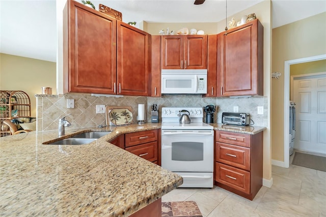 kitchen featuring light stone countertops, sink, tasteful backsplash, white appliances, and light tile patterned floors