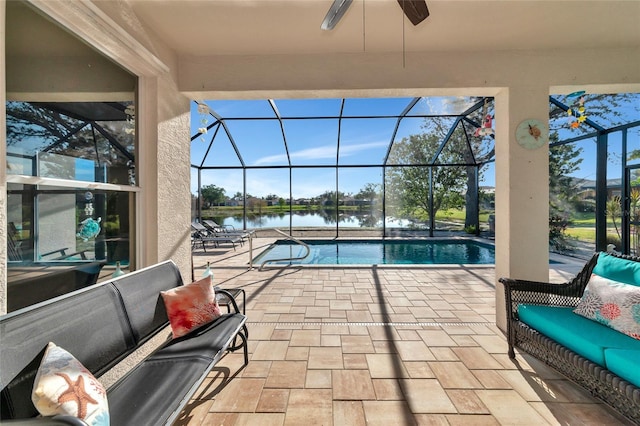 view of swimming pool featuring a lanai, ceiling fan, a water view, and a patio