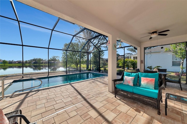 view of swimming pool featuring outdoor lounge area, ceiling fan, a water view, glass enclosure, and a patio