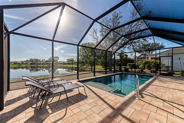 view of swimming pool with glass enclosure, a water view, and a patio