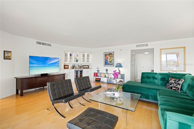 living room featuring wine cooler and light wood-type flooring