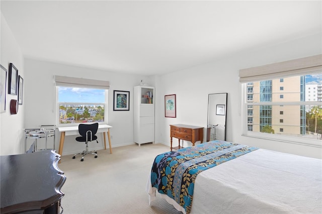 bedroom featuring light colored carpet