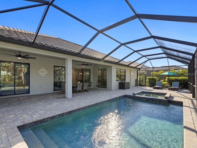 view of swimming pool with an in ground hot tub, a patio, glass enclosure, and ceiling fan