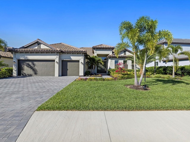 view of front of property with a front yard and a garage