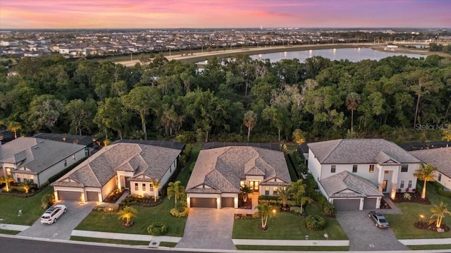 aerial view at dusk with a water view