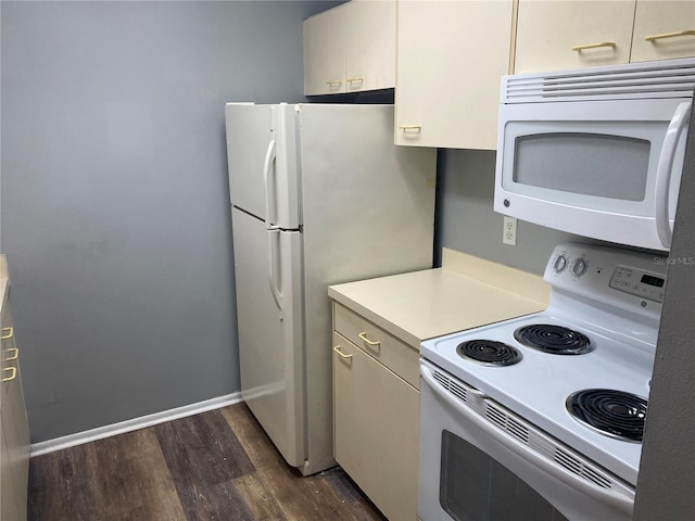 kitchen with dark hardwood / wood-style flooring and white appliances