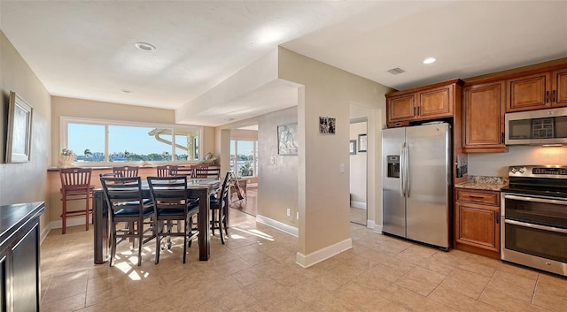 kitchen featuring light stone counters and stainless steel appliances