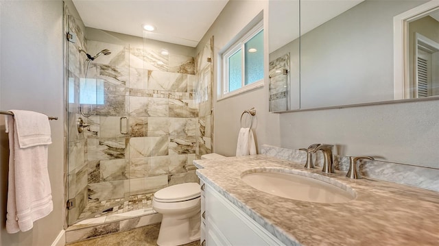 bathroom with vanity, toilet, and a shower with shower door