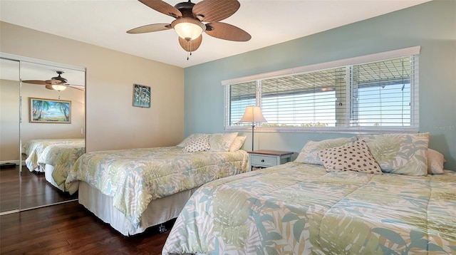 bedroom with dark hardwood / wood-style flooring, ceiling fan, and a closet