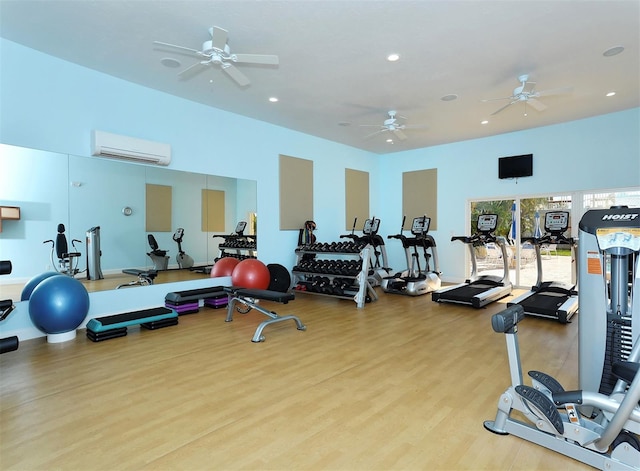 workout area with light hardwood / wood-style flooring and a wall mounted AC