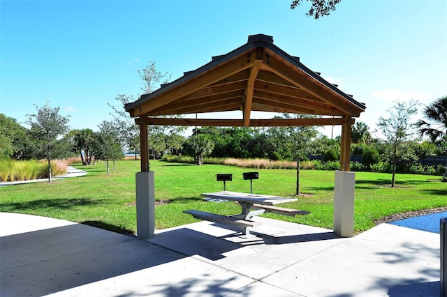 view of community featuring a gazebo, a patio area, and a lawn