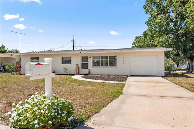 ranch-style house with a garage and a front lawn