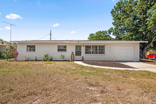 ranch-style home with a garage and a front yard