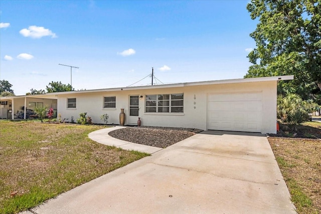 ranch-style house featuring a front yard and a garage