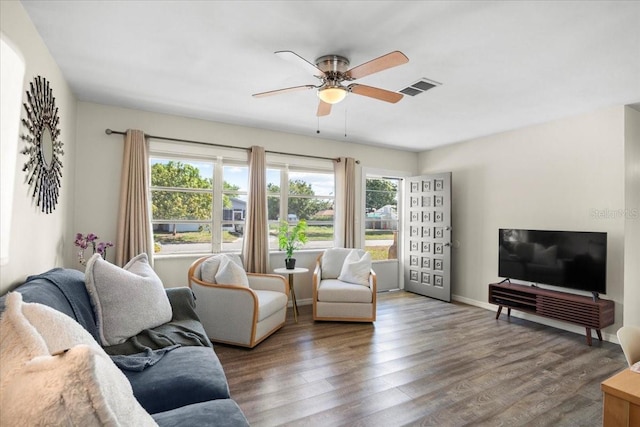 living room featuring wood-type flooring and ceiling fan