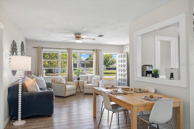 dining area with hardwood / wood-style flooring and ceiling fan