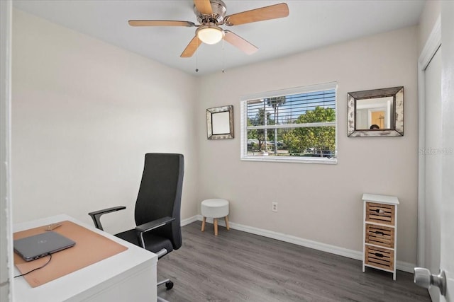 home office with dark hardwood / wood-style floors and ceiling fan