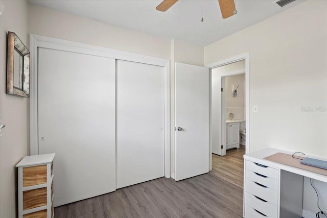 bedroom featuring ceiling fan, a closet, and light wood-type flooring