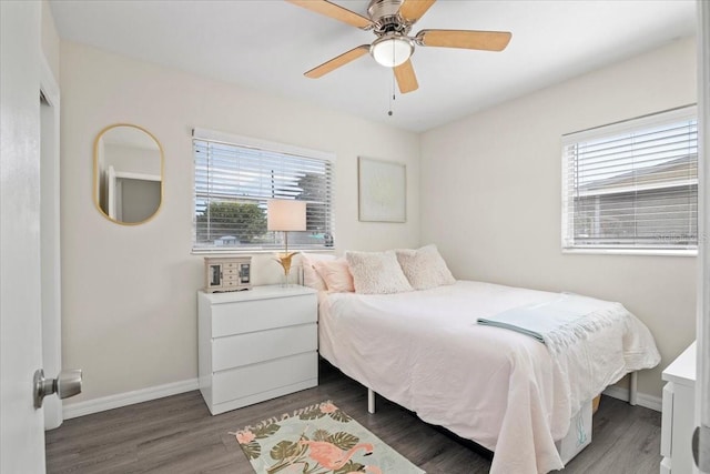 bedroom with multiple windows, wood-type flooring, and ceiling fan