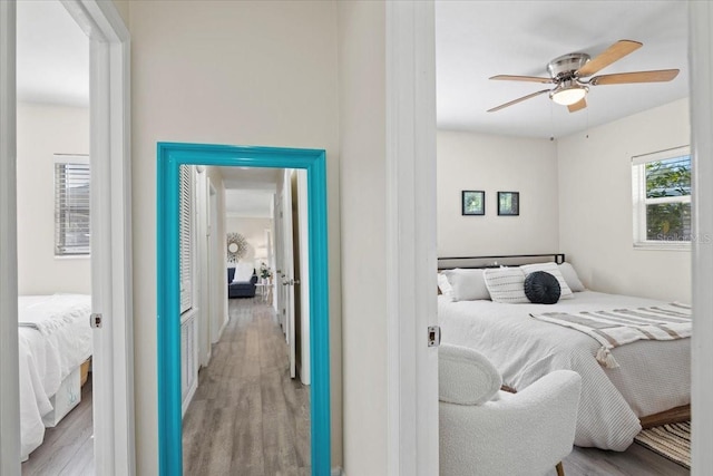 bedroom with ceiling fan and light hardwood / wood-style floors