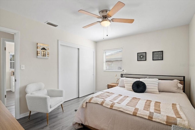 bedroom with wood-type flooring, a closet, and ceiling fan