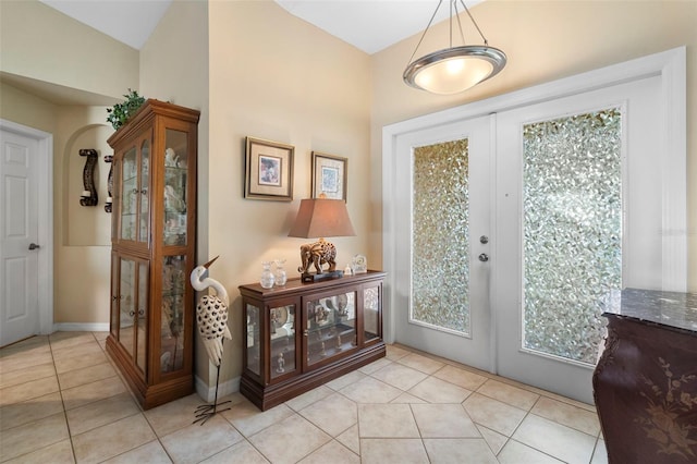 entryway featuring french doors and light tile patterned floors