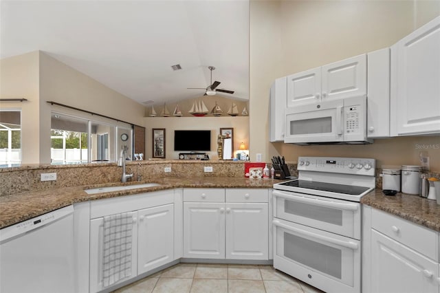 kitchen featuring white cabinetry, sink, white appliances, and lofted ceiling