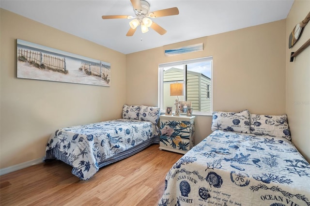 bedroom with hardwood / wood-style flooring and ceiling fan