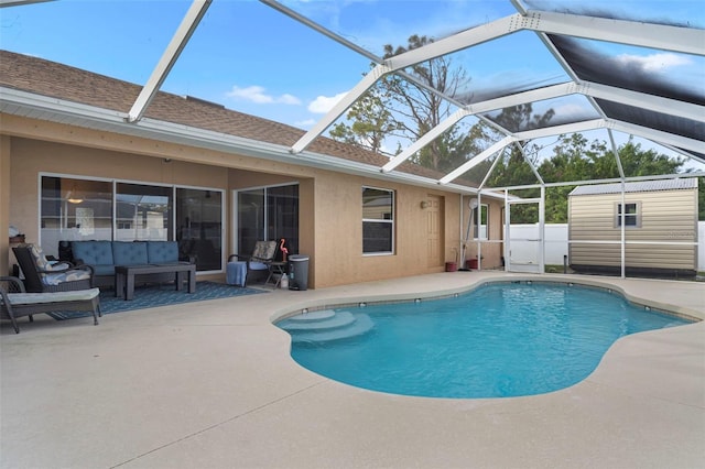 view of pool with a storage shed, a lanai, and a patio