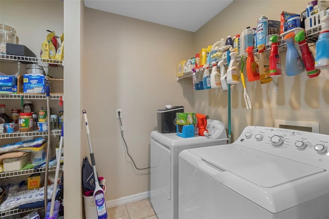 laundry room with light tile patterned flooring and washer and clothes dryer