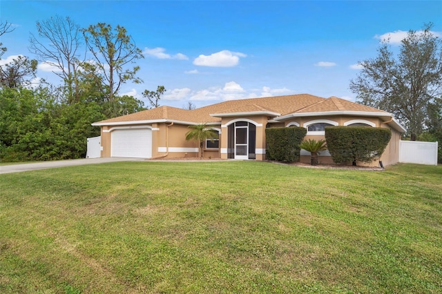 mediterranean / spanish home with stucco siding, fence, a garage, driveway, and a front lawn