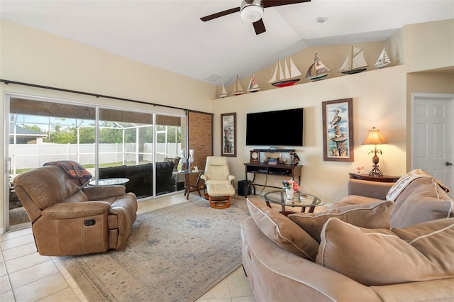 living room with vaulted ceiling, ceiling fan, and light tile patterned floors