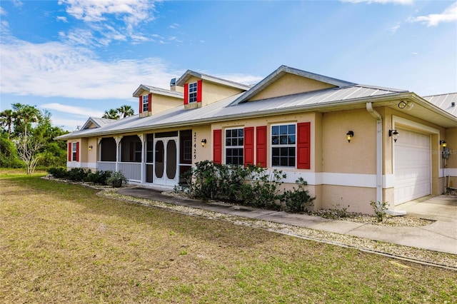 view of front of property featuring a garage and a front lawn