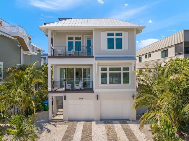 view of front of property with a garage and a balcony