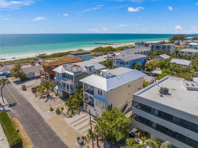 drone / aerial view featuring a water view and a beach view