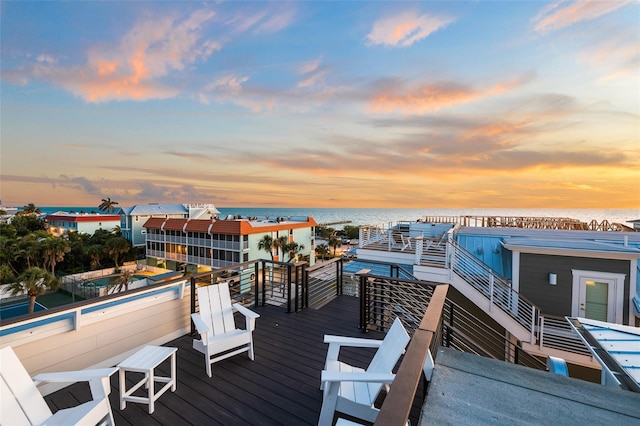 dock area featuring a water view and a swimming pool