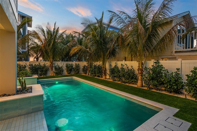 view of pool at dusk