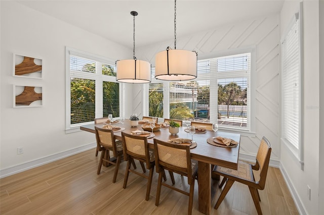 dining space featuring a wealth of natural light and light wood-type flooring