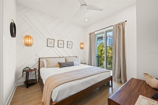 bedroom featuring access to exterior, light hardwood / wood-style floors, and ceiling fan