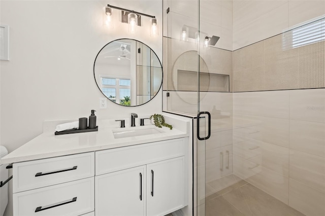 bathroom with vanity and a shower with door