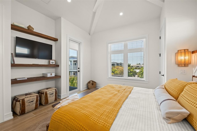 bedroom with access to outside and beam ceiling