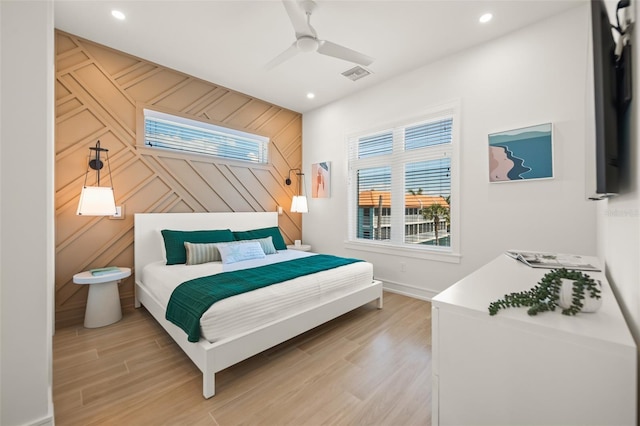 bedroom featuring ceiling fan and light hardwood / wood-style flooring