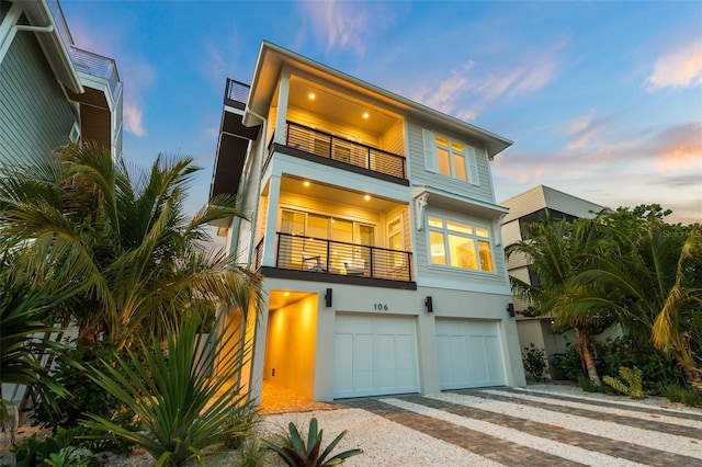 view of front facade with a garage and a balcony