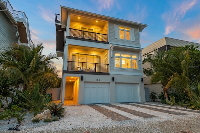 view of front facade with a balcony and a garage