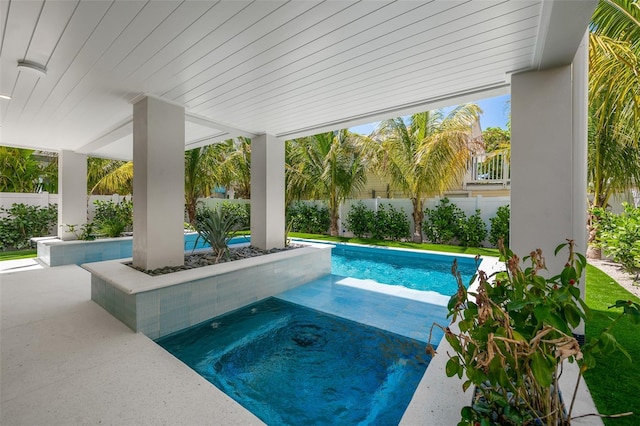 view of swimming pool with a hot tub