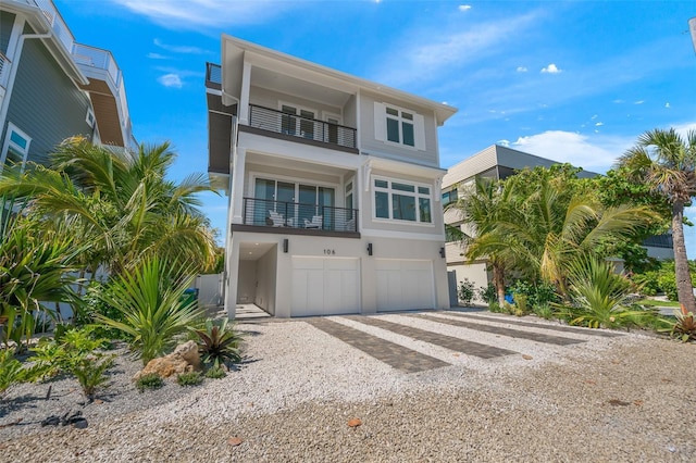 view of front of home with a balcony and a garage