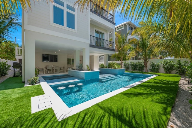 view of swimming pool with a patio area and a yard