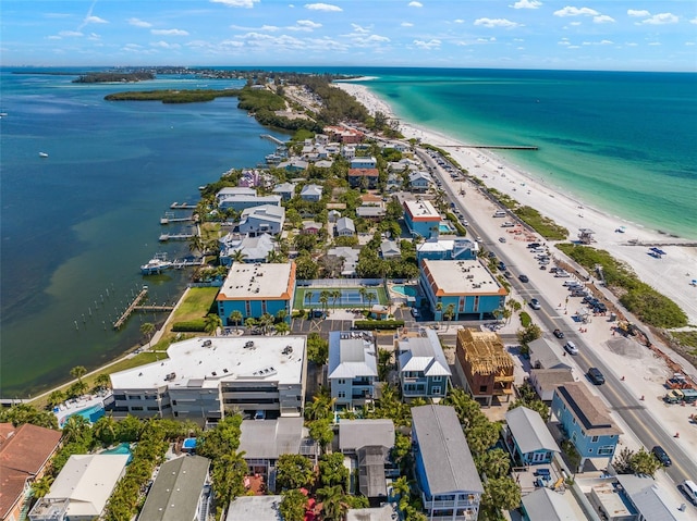 drone / aerial view featuring a water view and a beach view