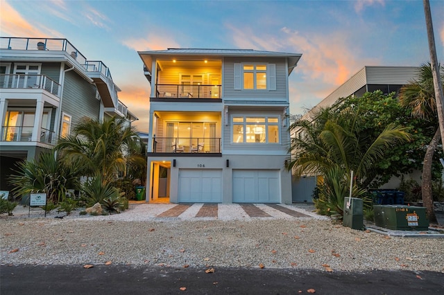 view of front of home featuring a balcony and a garage