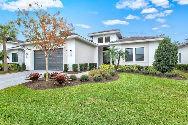 view of front of property featuring a garage and a front yard